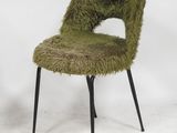 a green chair with black legs and a furry seat