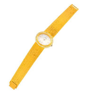 une image représentant une montre jaune dotée d'une lunette sertie de diamants