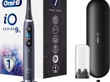 a close up of an electric toothbrush with a box of toothpaste in the background