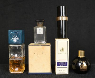 three bottles of perfume sitting next to each other on a table