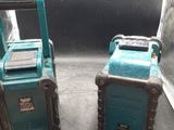 two blue and black radio ' s sitting on the floor