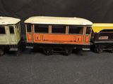 three toy trains sitting next to each other on a black surface