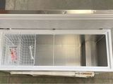 a small freezer with a door open on the floor