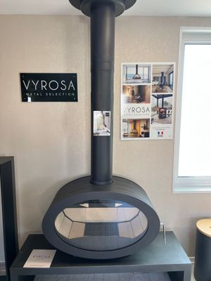 a black stove in the corner of a living room