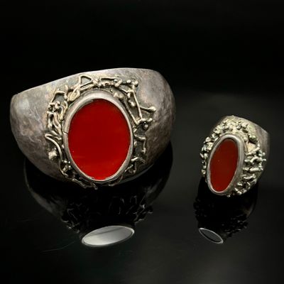 une image représentant une bague en argent sertie d'une pierre rouge