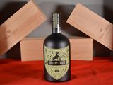 a bottle of liquor sitting on a red cloth