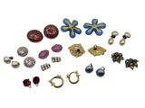 many different types of earrings and rings on a white surface