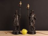 two figurines of a man and a woman standing next to each other