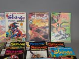 a lot of comic books sitting on a table