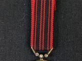 an image of a medal with a cross on it
