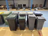 many trash cans sitting in a large warehouse