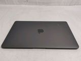 a black apple laptop sitting on a white surface