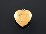 a close up of a gold heart with stars on it