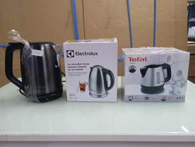 two electric kettles on the counter next to each other