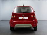 a small red car that is parked in a garage