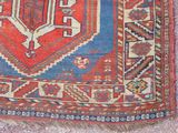 a red and blue rug with a bird on it