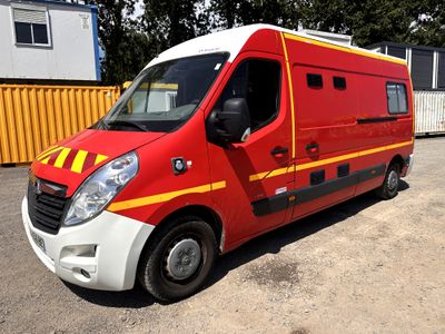 a red and yellow van parked in a parking lot