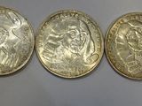 five different types of coins are lined up on a wall