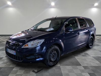 a picture of a blue ford focus parked in a garage