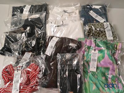 a lot of clothes that are wrapped in plastic bags