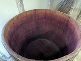 a woman that is standing next to a barrel