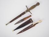 four different types of knifes on a white surface