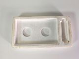 a close up of a small white object on a table