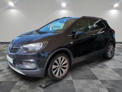 the black buick suv is parked on a checkered tile floor