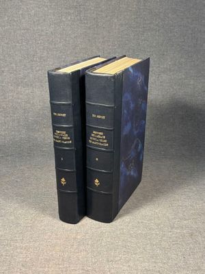 the two books are sitting side by side on a gray surface