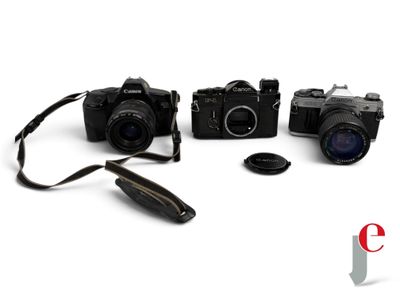 three cameras sitting next to each other on a white surface