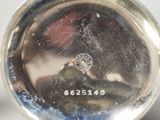 a close up of a silver plate with a picture on it