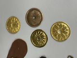 a lot of gold buttons and a pair of brown shoes