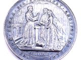 une image représentant une pièce de monnaie sur laquelle figurent un homme et une femme se serrant la main