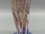 a glass vase with a pink and blue design on it