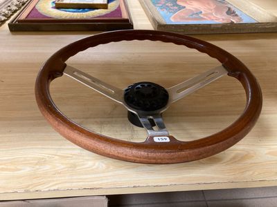 a wooden steering wheel on a table in a room