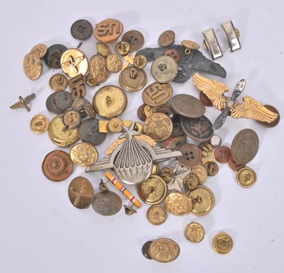 a pile of old buttons and other items on a table