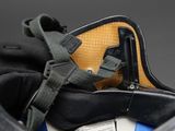 a bag that has a belt on it and a cell phone in it