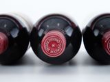 three bottles of wine sitting next to each other on a table