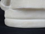 a close up of a white vase on a black background