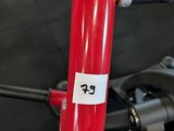 a red bicycle with a sticker on the handlebars