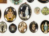 a lot of different religious items on the wall