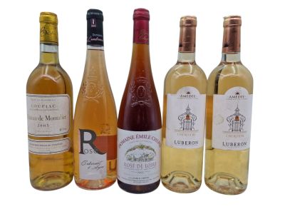 several bottles of wine are lined up on a white surface