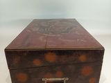 an old wooden box sitting on top of a white table