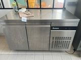 a stainless steel counter with a bottle of wine on top of it