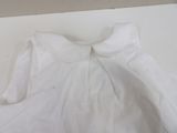 a white shirt with a large bow on it