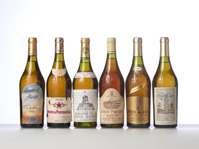 several bottles of wine are lined up on a table