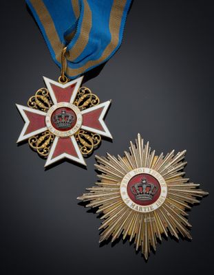 two medals and a medal on a black surface