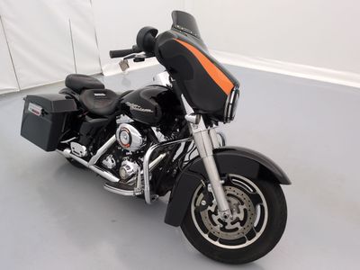 a black and orange motorcycle parked in a white room