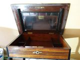 a small wooden box with a mirror on top of it
