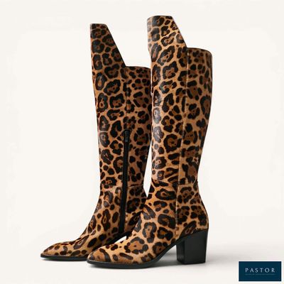 a pair of leopard print boots on a white background